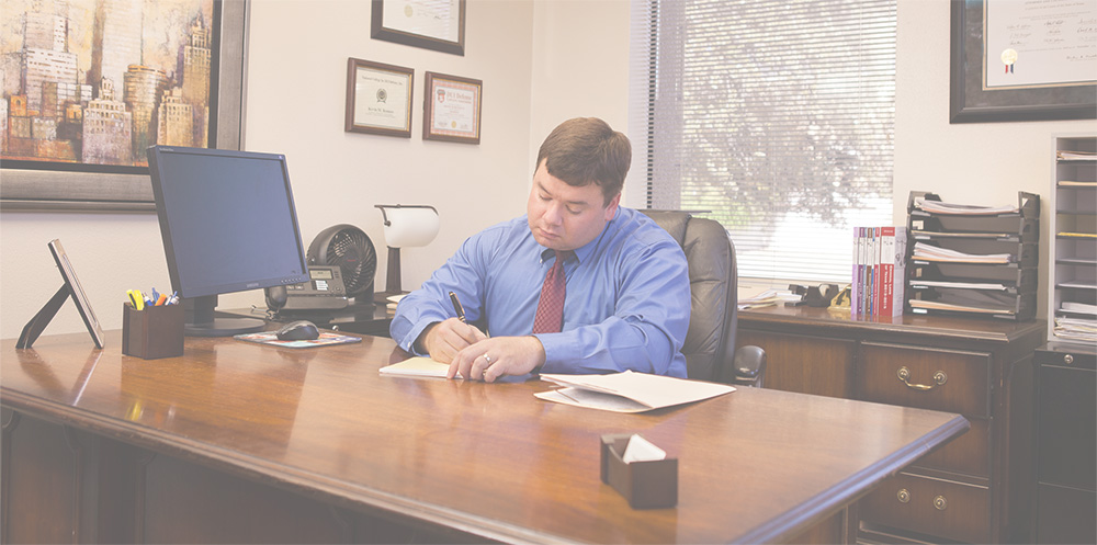 attorney Kevin Bennett sitting at his desk